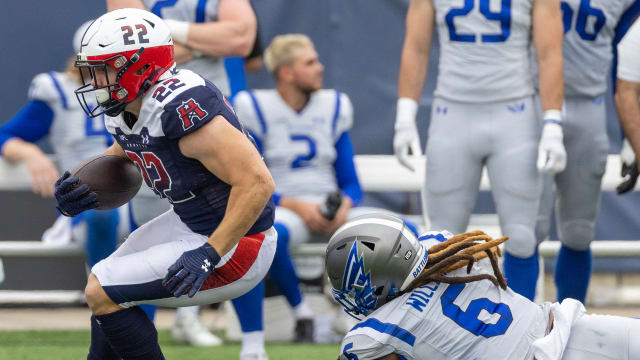 Apr 2, 2023; Houston, TX, USA; Houston Roughnecks running back Max Borghi (22) breaks the tackle of St. Louis Battlehawks linebacker Lake Williams (9) in the second quarter at TDECU Stadium. Mandatory Credit: Thomas Shea-USA TODAY Sports  